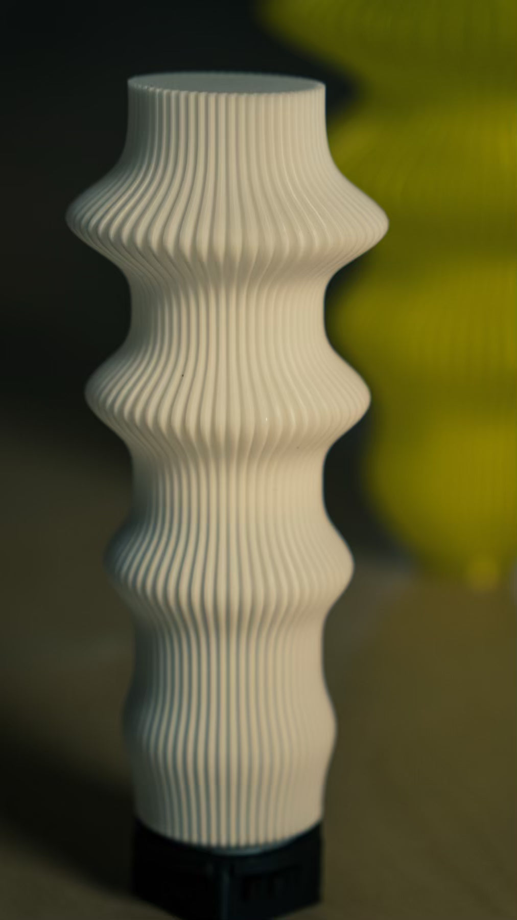 Muvèlo Ruvaa White portable lamp shown with other colourful sculptural rechargeable table lamps.