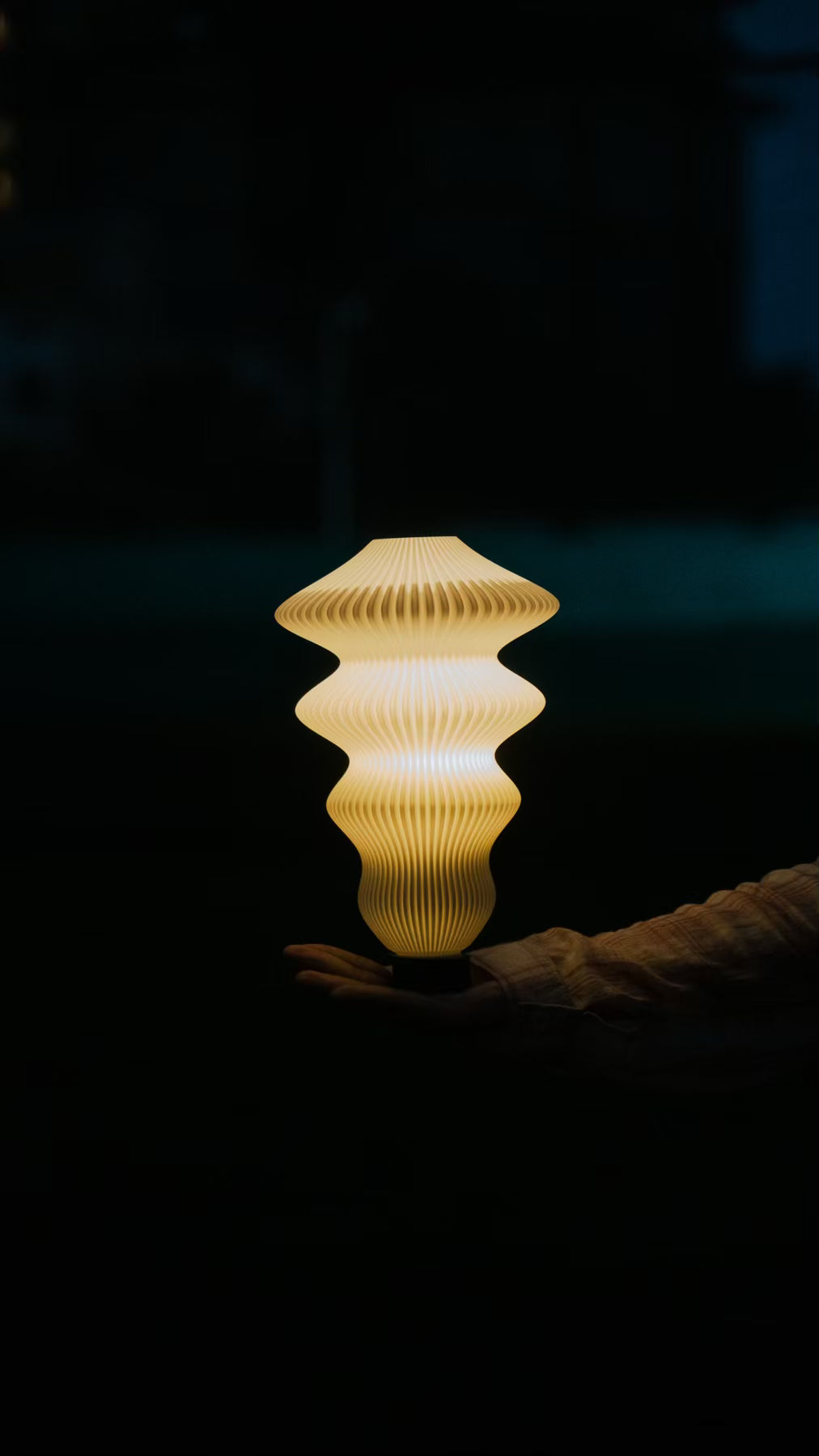 Sculptural profile of the Muvèlo Ruvaa Max White designer table lamp with a ribbed surface.