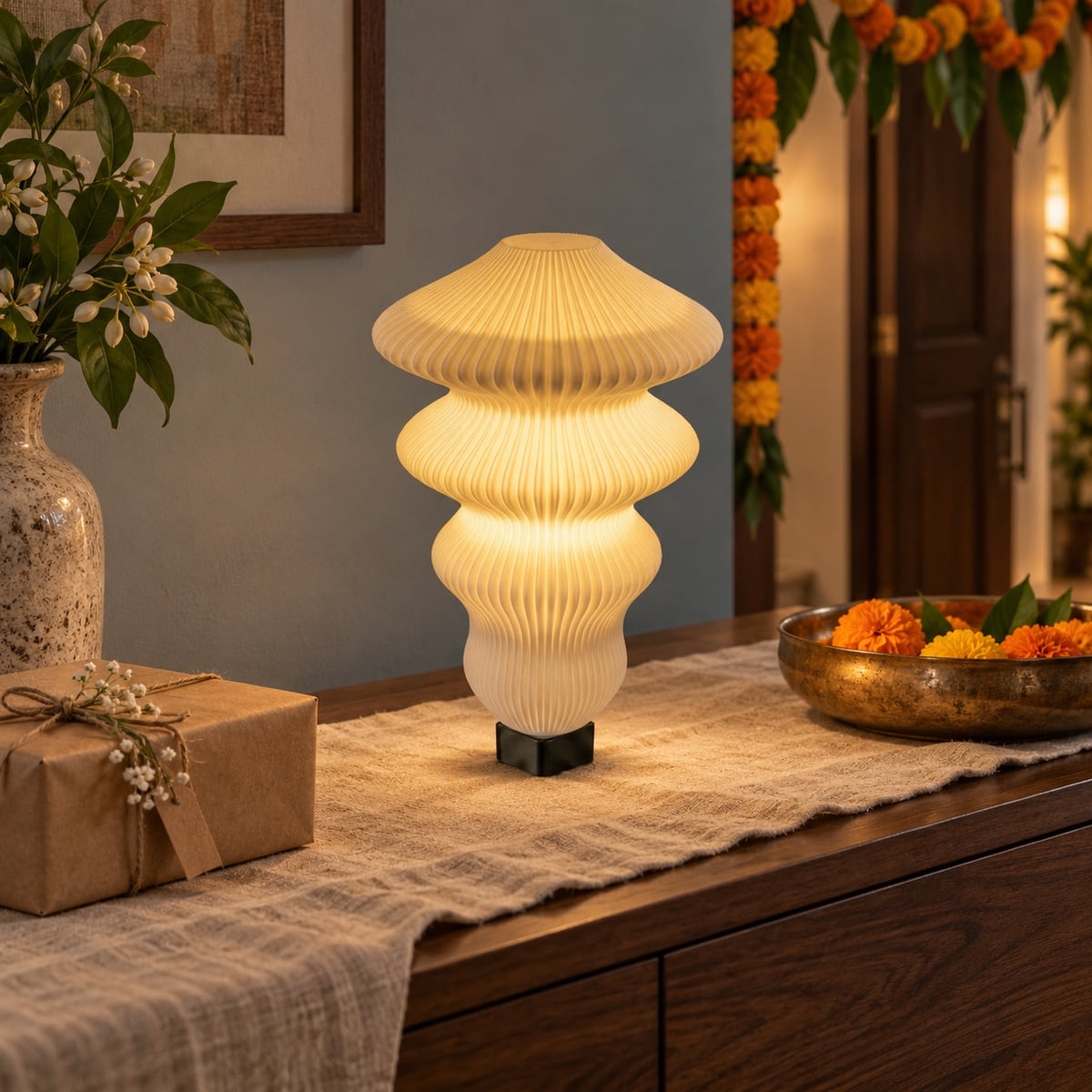 Ruvaa Max Vanilla lamp glowing on a surface in a Diwali setting with marigolds and festive home details.