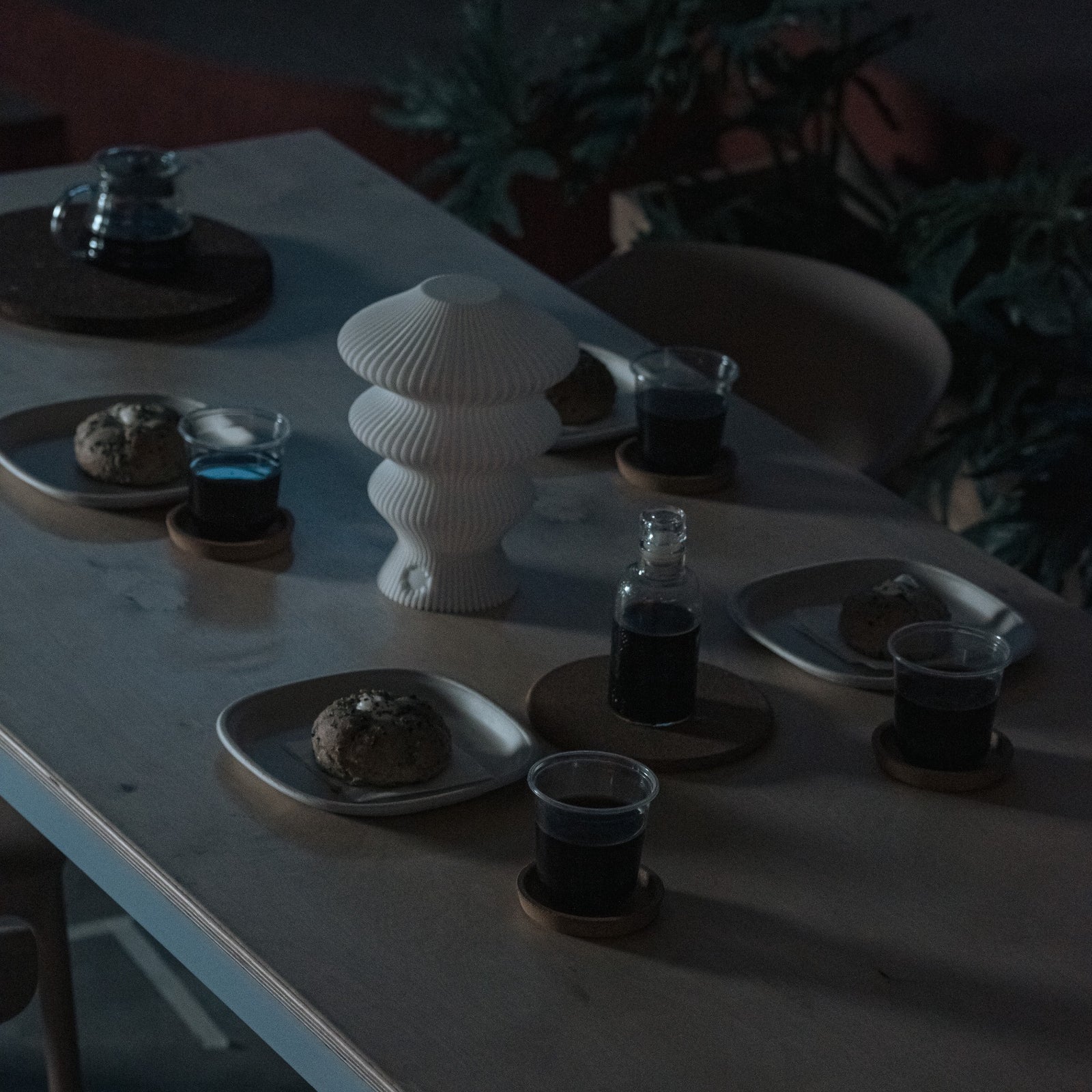 White Ruvaa Mono sculptural table lamp displayed in a low-light interior