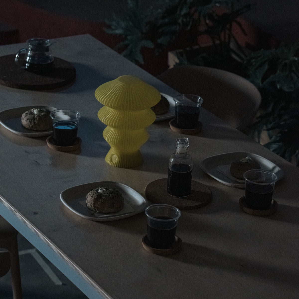 Yellow Ruvaa Mono sculptural table lamp displayed in a low-light interior