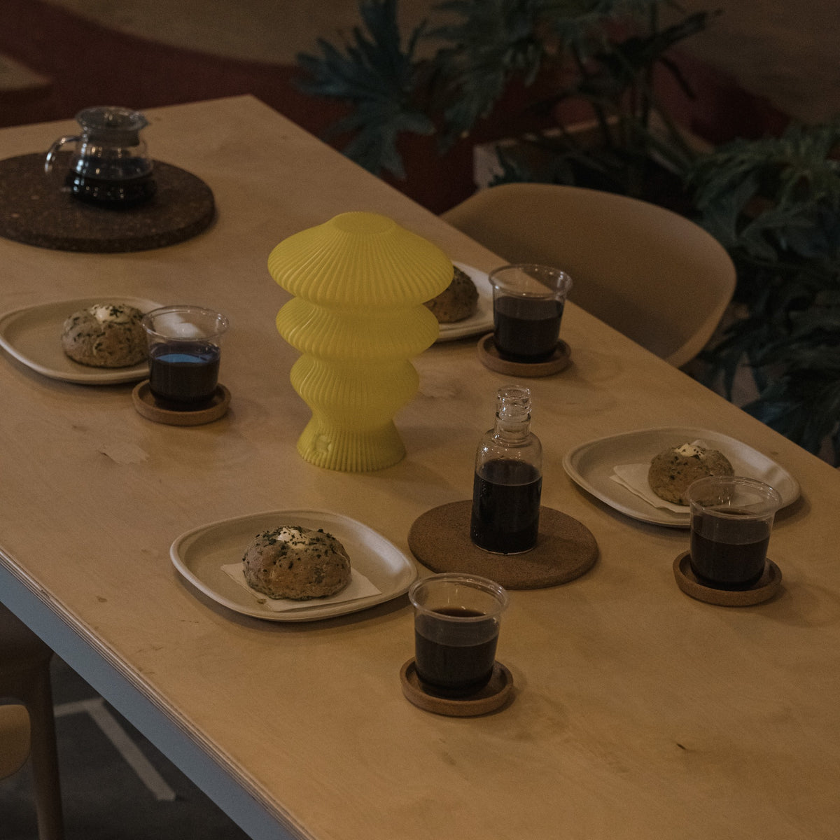Yellow Ruvaa Mono portable table lamp switched off on a dining table