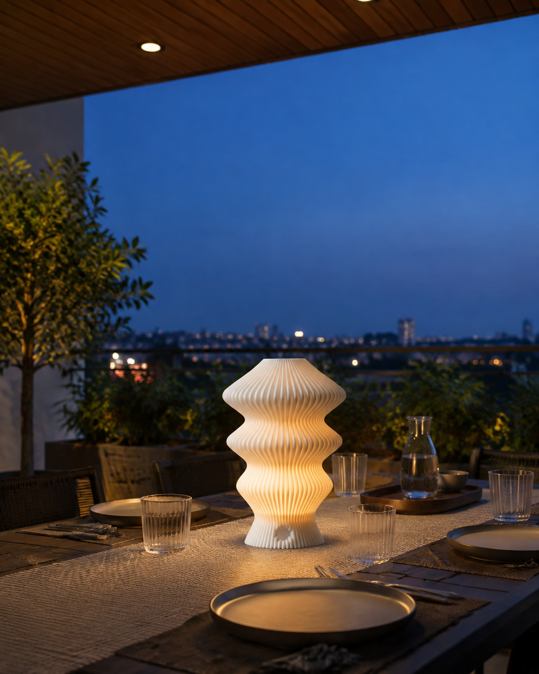 White Muvèlo Ruvaa Mono on a dry covered terrace dining table at blue hour