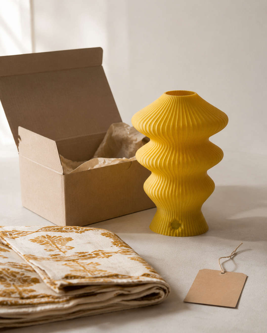 Yellow Muvèlo Ruvaa Mono packed with Indian cotton textile as a gift abroad