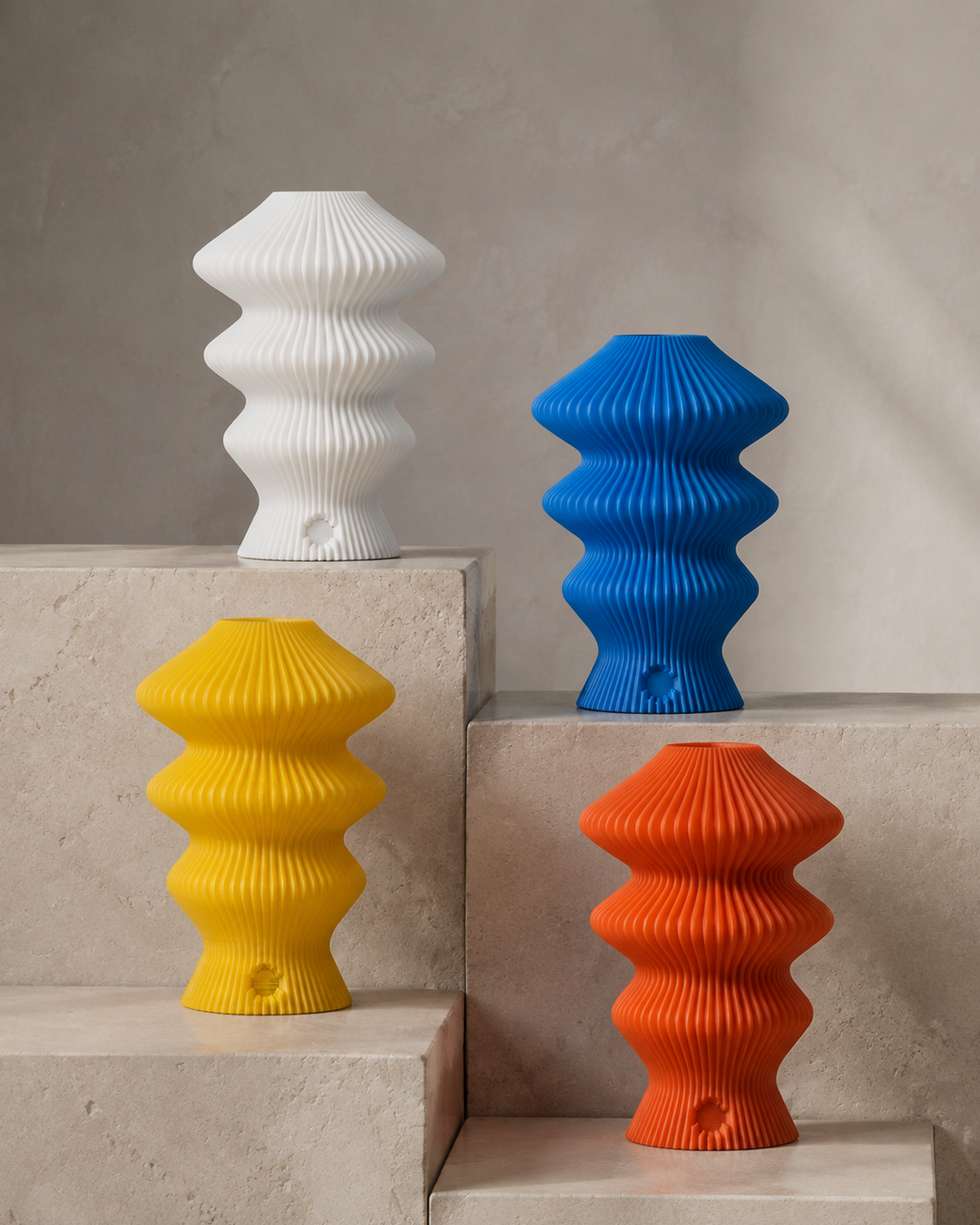 White, blue, yellow and orange Ruvaa Mono portable table lamps on stone plinths