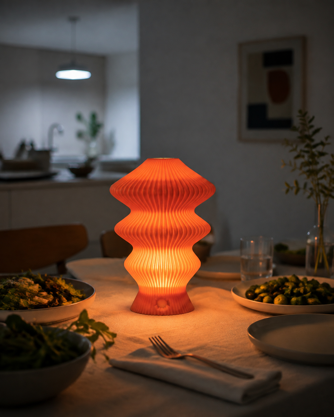 Orange Muvèlo Ruvaa Mono showing warm ambient light on a dining table