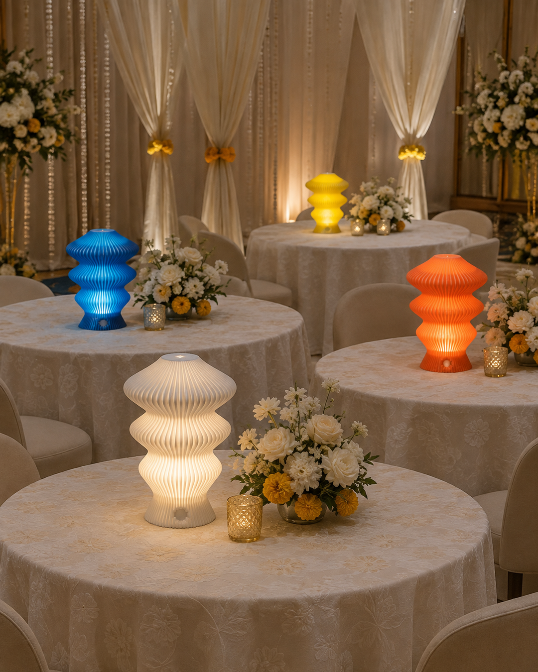 Four coloured Muvèlo Ruvaa Mono lamps lighting wedding reception tables