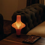 Decorative lamp on a wooden table with a dark sofa in the background