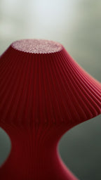 Close detail of the sculpted profile of the Muvèlo Volara Max Red Glass designer table lamp.