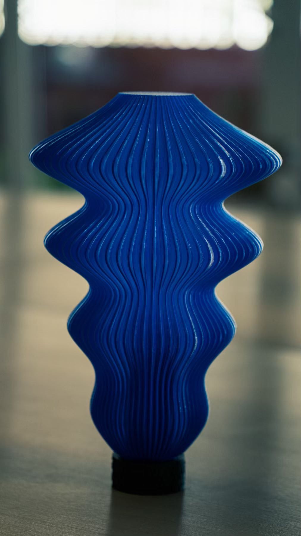 Muvèlo Ruvaa Max Blue portable rechargeable table lamp with a sculptural ribbed form.