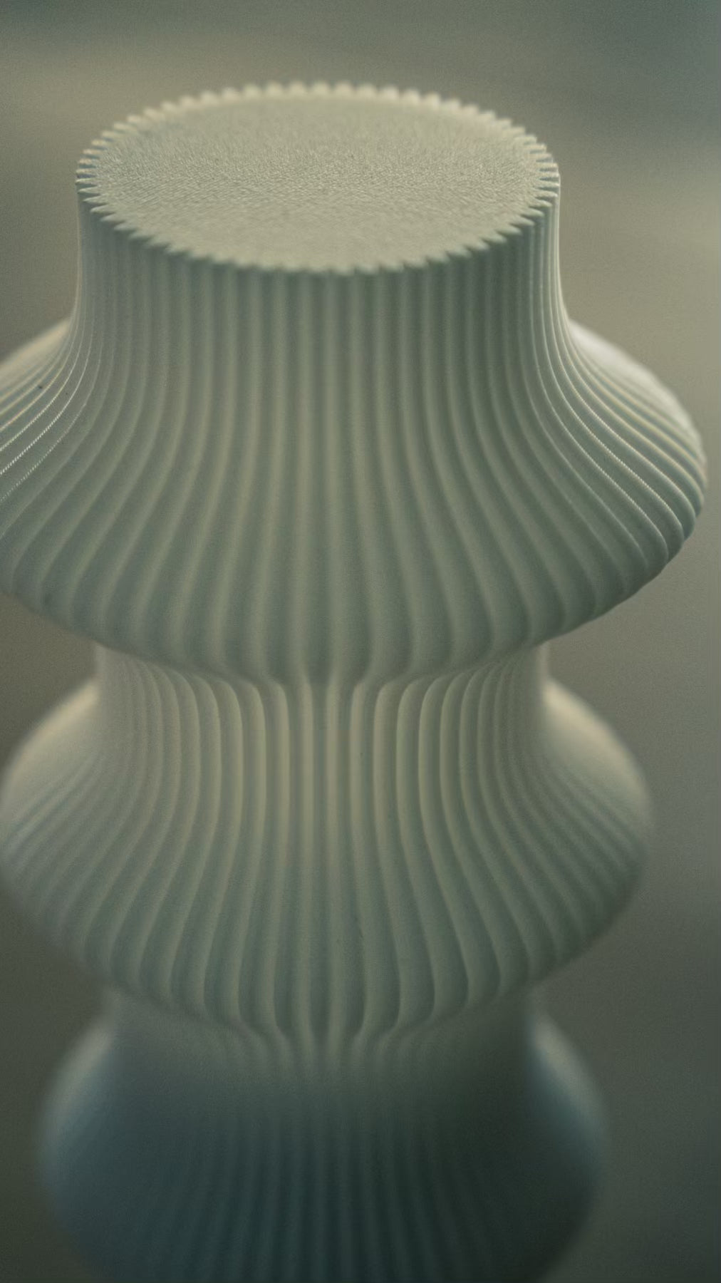 Close-up of the ribbed sculptural form of the Muvèlo Ruvaa White portable table lamp.