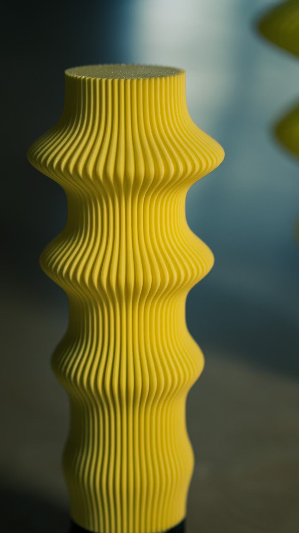 Close-up of the ribbed sculptural form of the Muvèlo Ruvaa Butter portable table lamp.