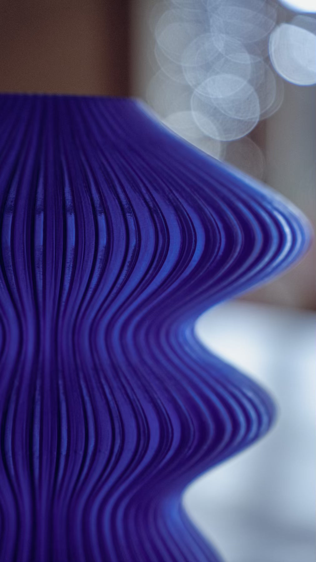 Surface detail of the Muvèlo Ruvaa Mono Blue rechargeable lamp showing its fine vertical ribs.