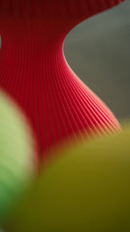Macro view of the flowing ribs on the Muvèlo Volara Max Red Glass portable ambient lamp.
