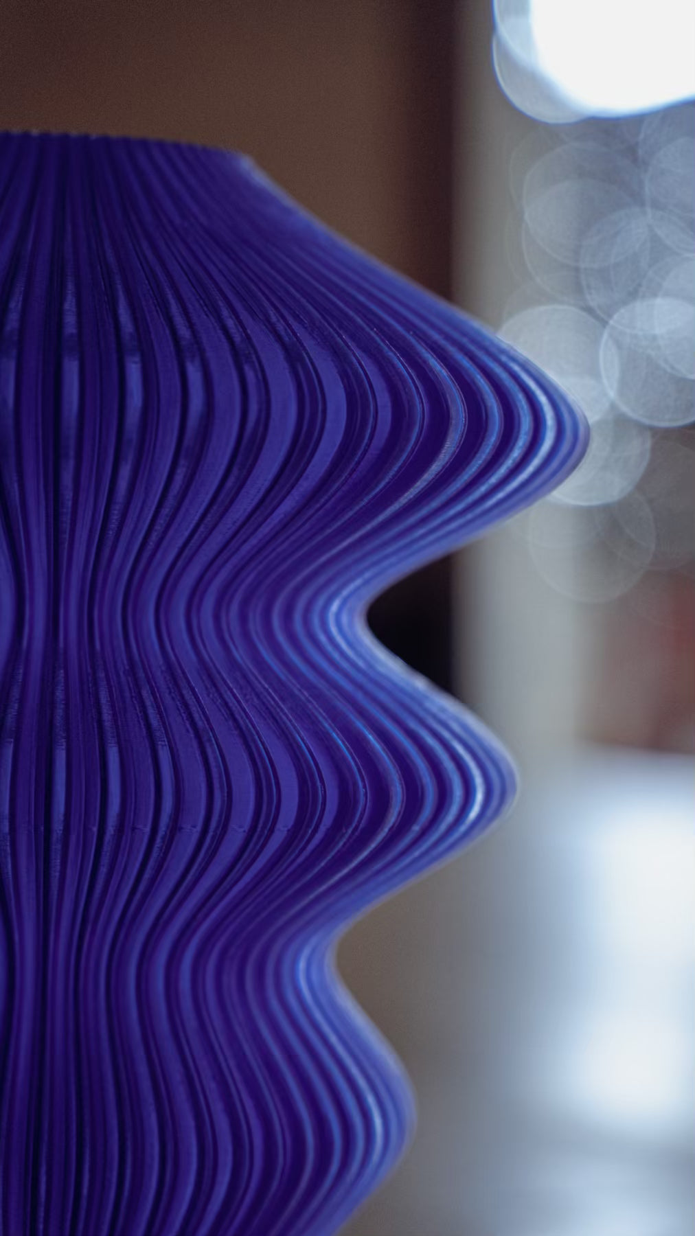 Macro view of the flowing ribs on the Muvèlo Ruvaa Mono Blue portable ambient lamp.
