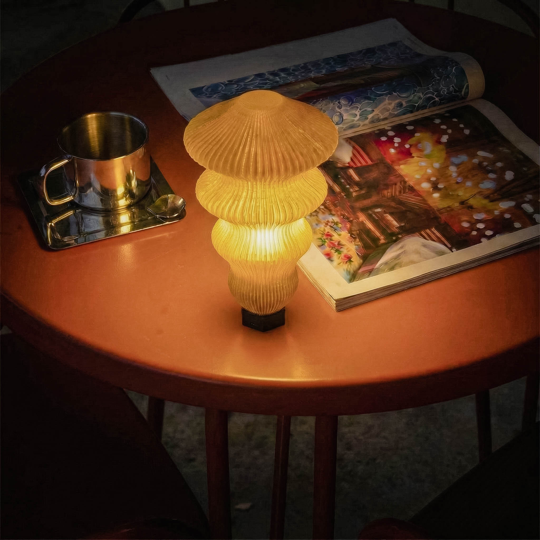 Decorative lamp on a wooden table with magazines and a cup in the background Yellow textured PORTABLE MODULAR TABLE LAMP on a red table with a magazine