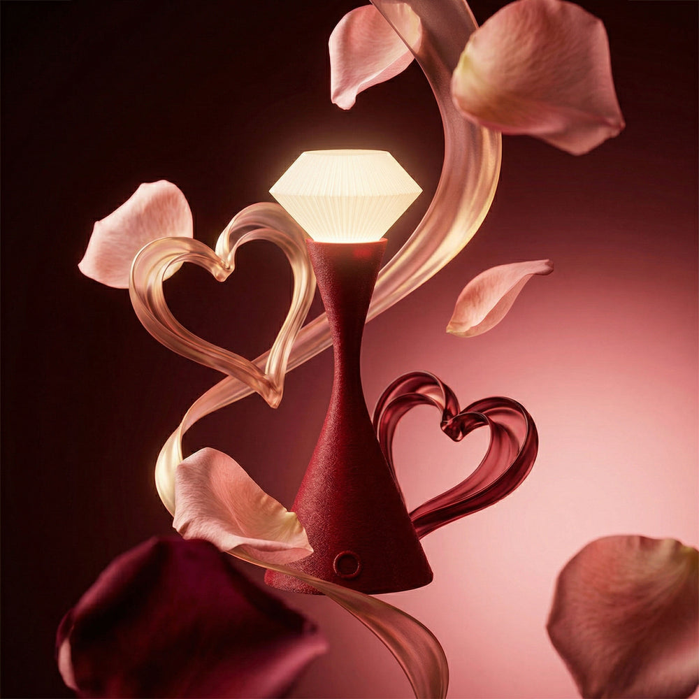Decorative lamp with heart design surrounded by pink flower petals on a dark background