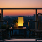 Lamp on a table with chairs and a sunset view