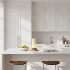 Modern kitchen with white cabinetry, a countertop, and two wooden stools.