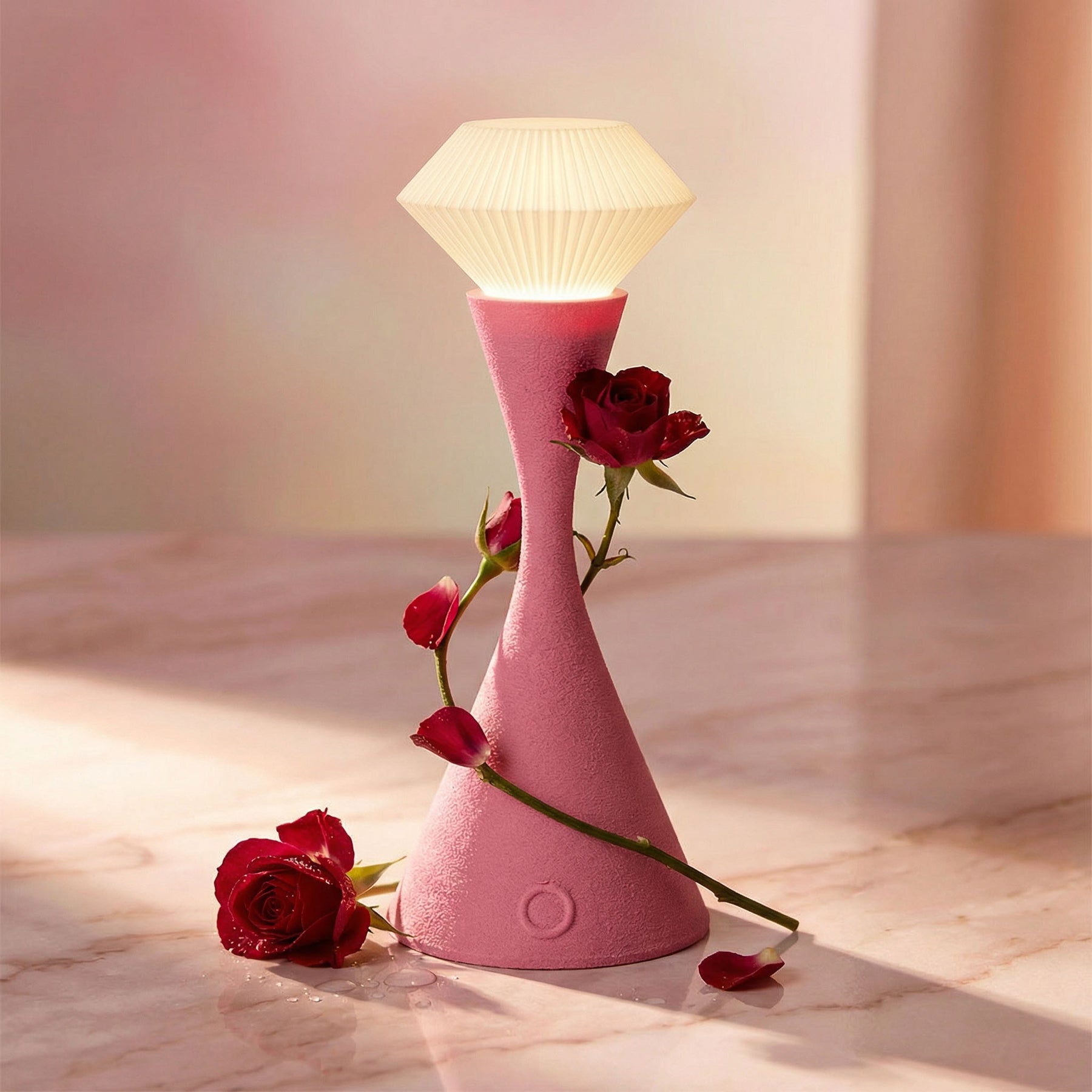 Pink lamp with red roses on a marble surface