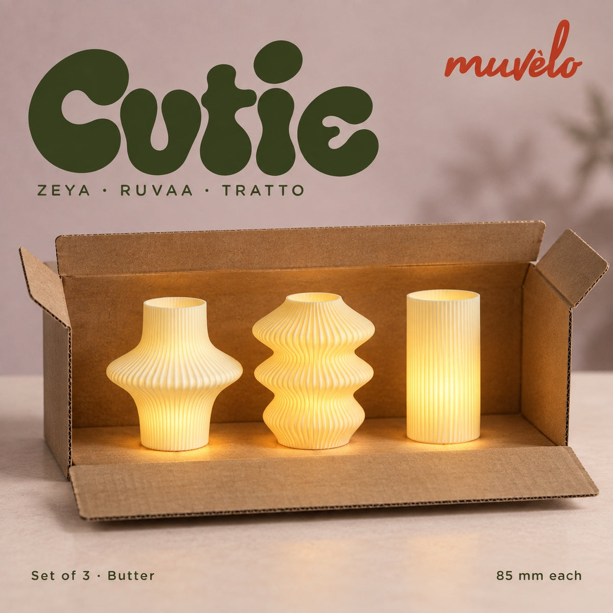Three illuminated Butter Cutie lamps — Zeya, Ruvaa, Tratto — displayed together in an open plain cardboard box.