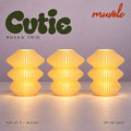 Muvèlo Cutie set of three in Butter: Ruvaa, Ruvaa, Ruvaa, all illuminated and shown together.