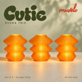 Muvèlo Cutie set of three in Orange Glass: Ruvaa, Ruvaa, Ruvaa, all illuminated and shown together.