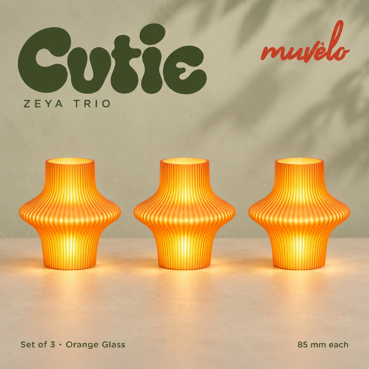 Muvèlo Cutie set of three in Orange Glass: Zeya, Zeya, Zeya, all illuminated and shown together.