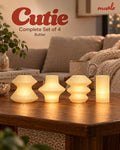 Cutie Butter Complete Set of 4 glowing on a cosy living-room table: Volara, Zeya, Ruvaa and Tratto.