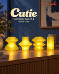 Cutie Yellow Glass Complete Set of 4 glowing on a blue-hour console: Volara, Zeya, Ruvaa and Tratto.