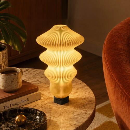 Muvèlo Ruvaa Max Butter table lamp glowing on a stone side table in a retro interior