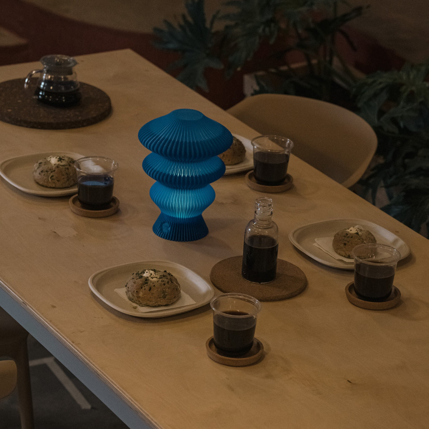 Blue Ruvaa Mono rechargeable ambient table lamp glowing on a dining table