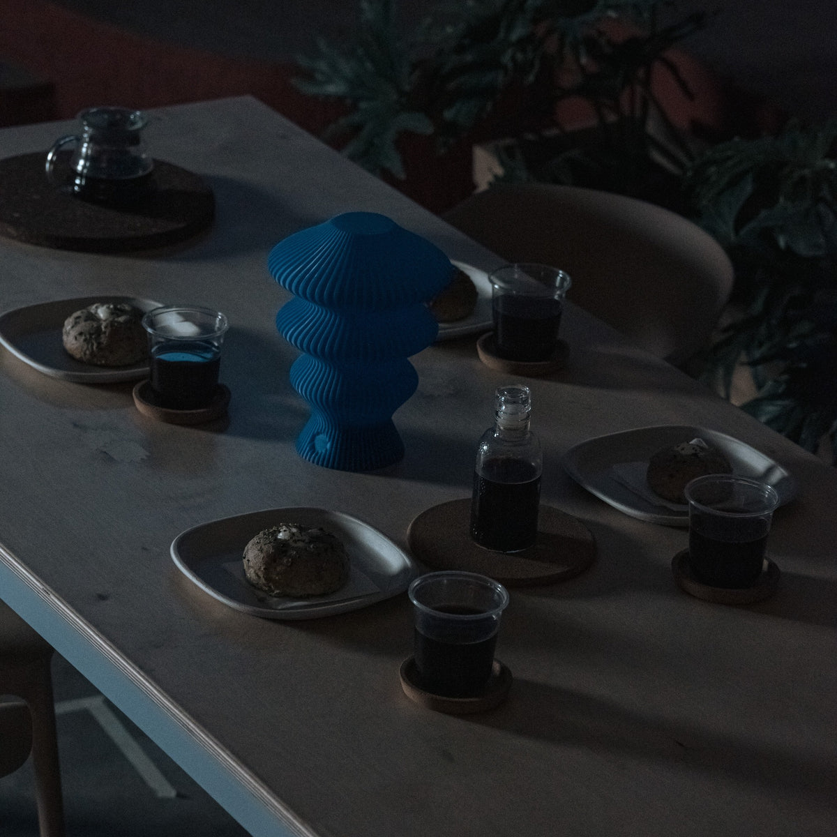 Blue Ruvaa Mono sculptural table lamp displayed in a low-light interior