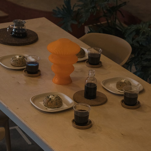 Orange Ruvaa Mono portable table lamp switched off on a dining table