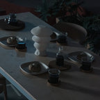 White Ruvaa Mono sculptural table lamp displayed in a low-light interior