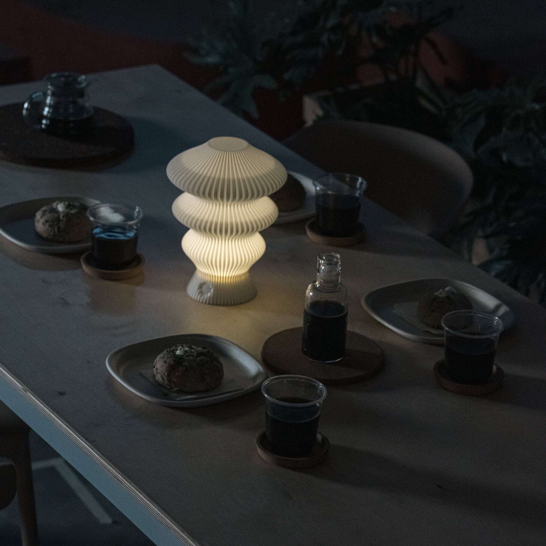 White Ruvaa Mono cordless ambient lamp on a table in the evening