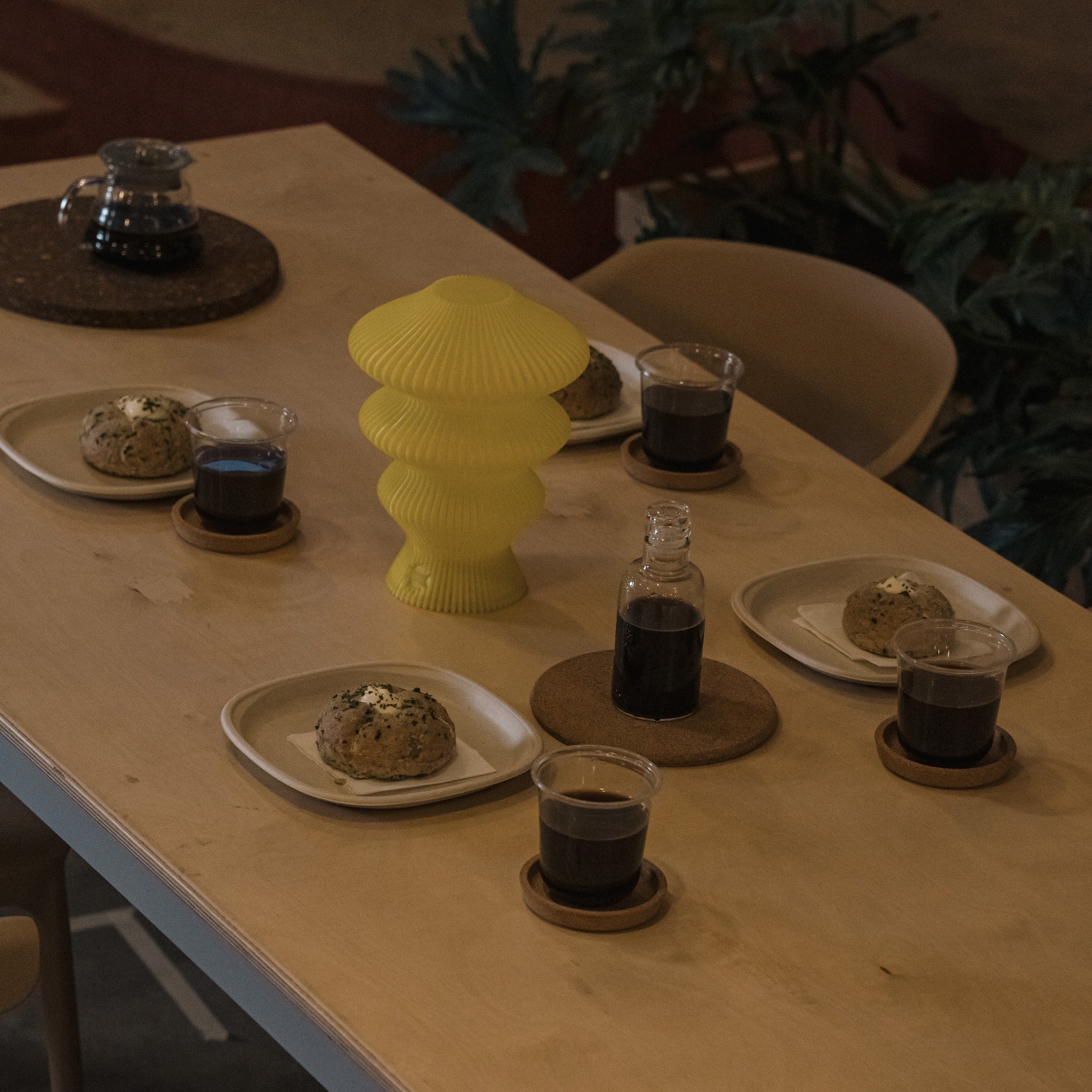 Yellow Ruvaa Mono portable table lamp switched off on a dining table